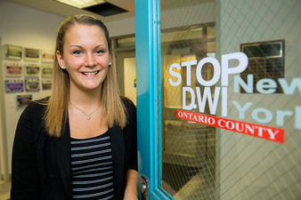Brittany Heysler, a Criminal Justice degree graduate, outside of her internship with Ontario County.